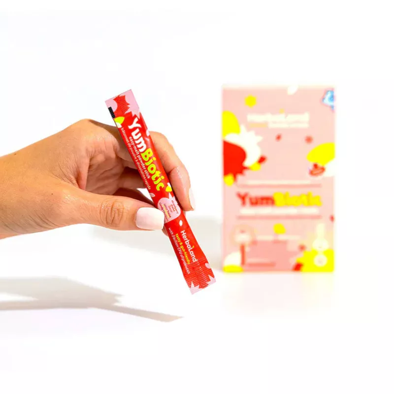 YumBiotic Supplement: Vibrant Red Packet Close-Up Hand holding YumBiotic red packet, health supplement, sleek design, vibrant colors, branding focus.